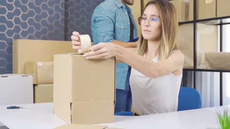 partners working together in the warehouse of an online store prepare orders.