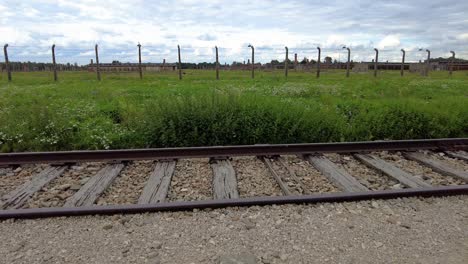 view of old train tracks barbed wire fences