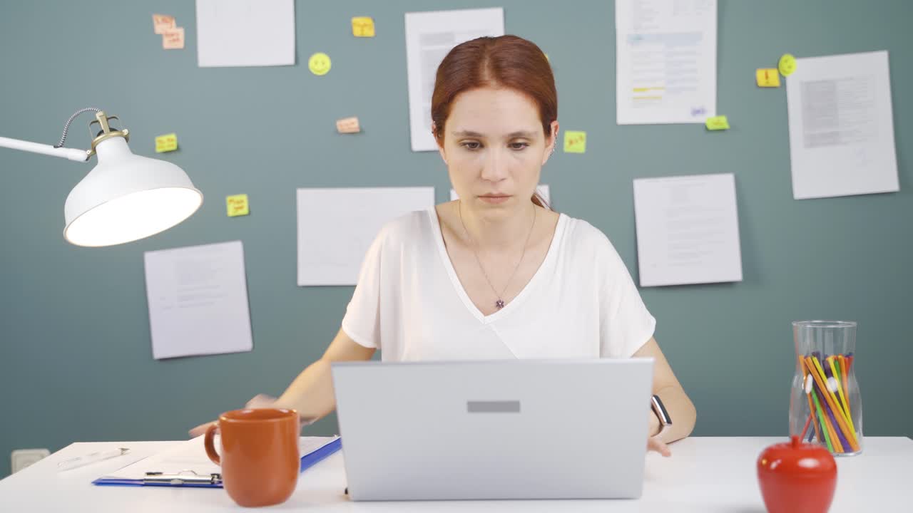 Concentrated woman working on laptop.