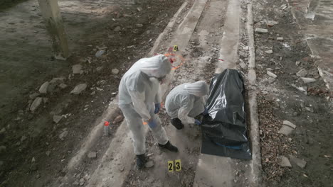 two forensic specialists are working at the crime scene