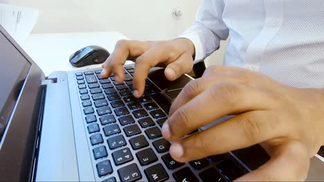 close up asian indian man hands typing using computer keyboard