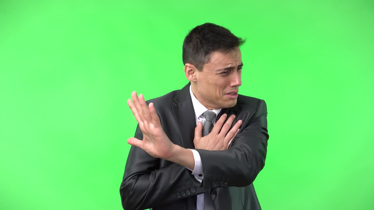Man showing disgust and rejection on green screen