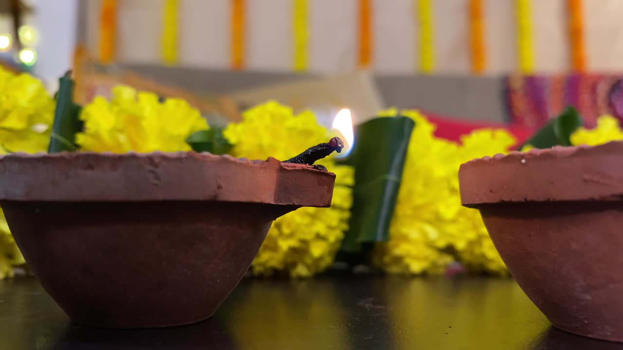 Lighting a diya (oil lamp) with a matchstick