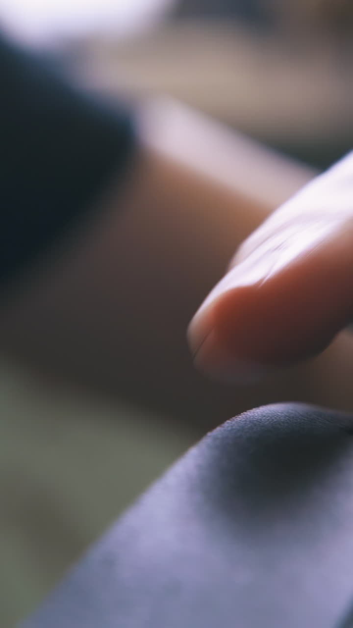 CU: Skilled designer makes holes in stylish leather belt with special punch pliers in workshop closeup
