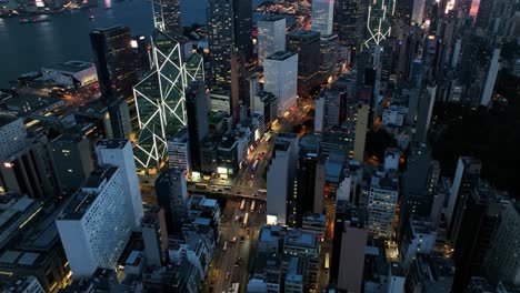 experience the dynamic energy of a cityscape as twilight descends. skyscrapers rise above busy streets, showcasing city life and illuminated buildings.