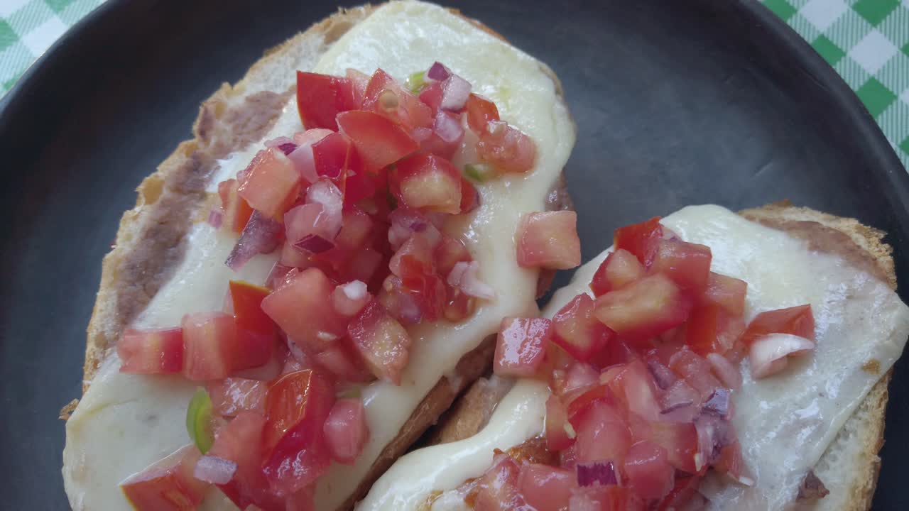 Delicious molletes with melted cheese and fresh salsa topping