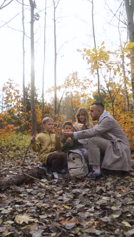 family sitting around a dead tree