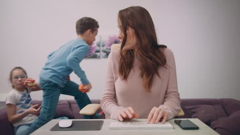 Children-have-fun-with-working-mom.-Female-freelancer-multitasking-at-home