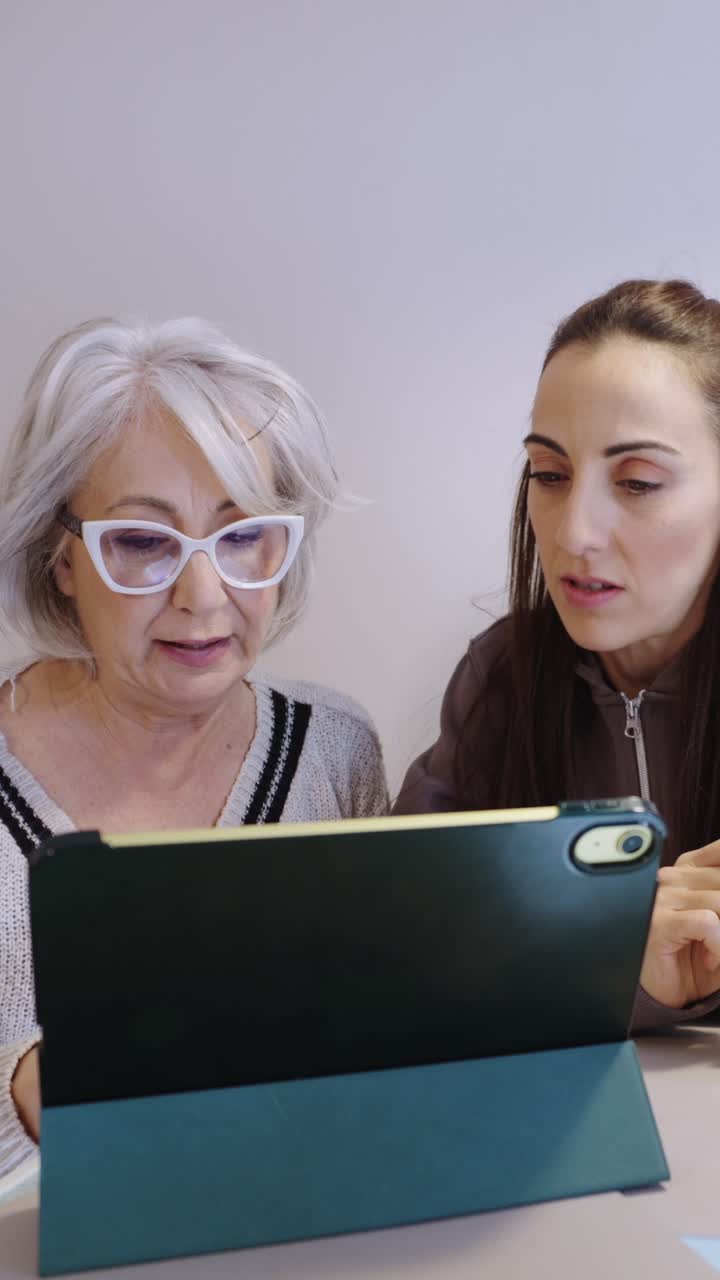 Two women using a tablet