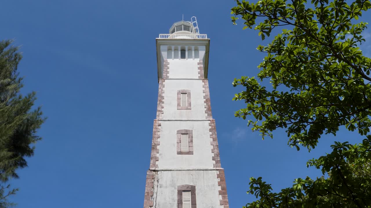 Point Venus historic lighthouse, Papeete, Tahiti, French Polynesia.Slow tilt down camera.