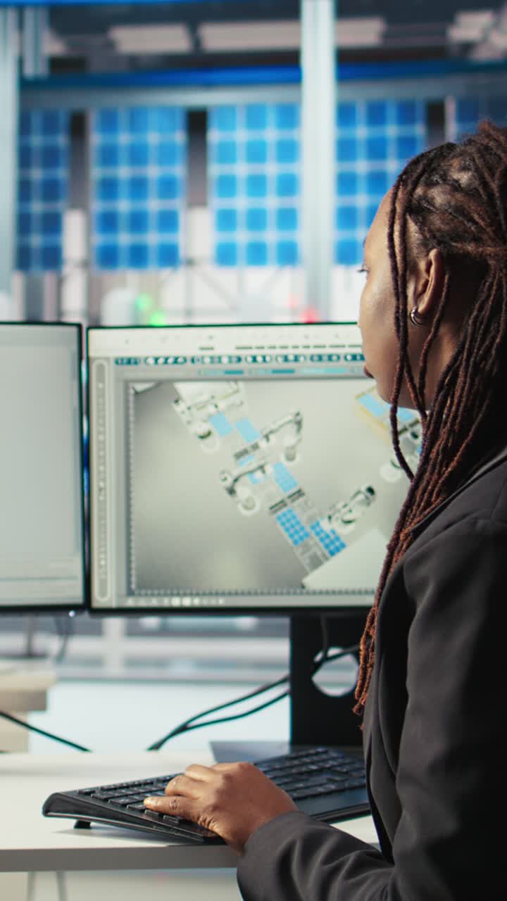 Vertical Video Woman Coding At Computer Desk Looking On Screen, Upgrading Solar Plant Machinery