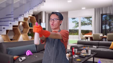 funny asian male housekeeper with an apron using a spray while standing in house