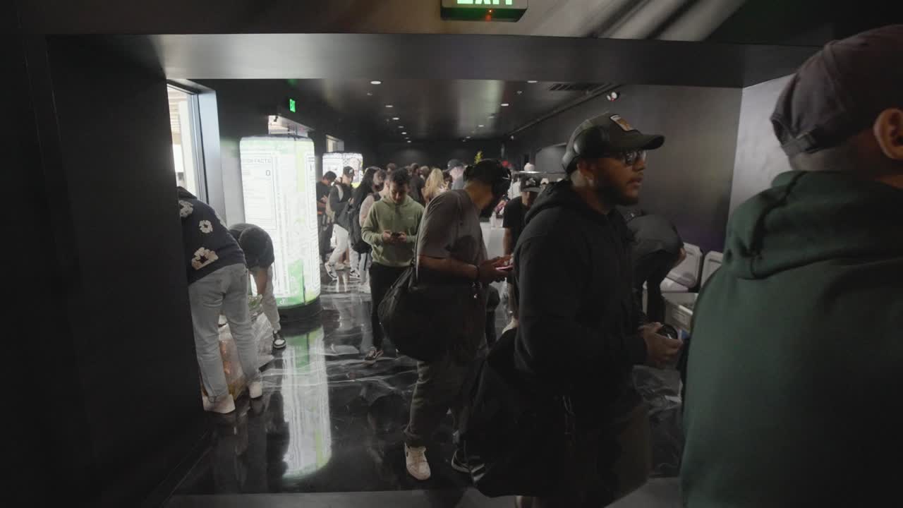 Crowd of People Walking Through a Hallway at an Event