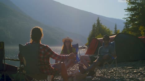 group of friends camping near riverside 4k