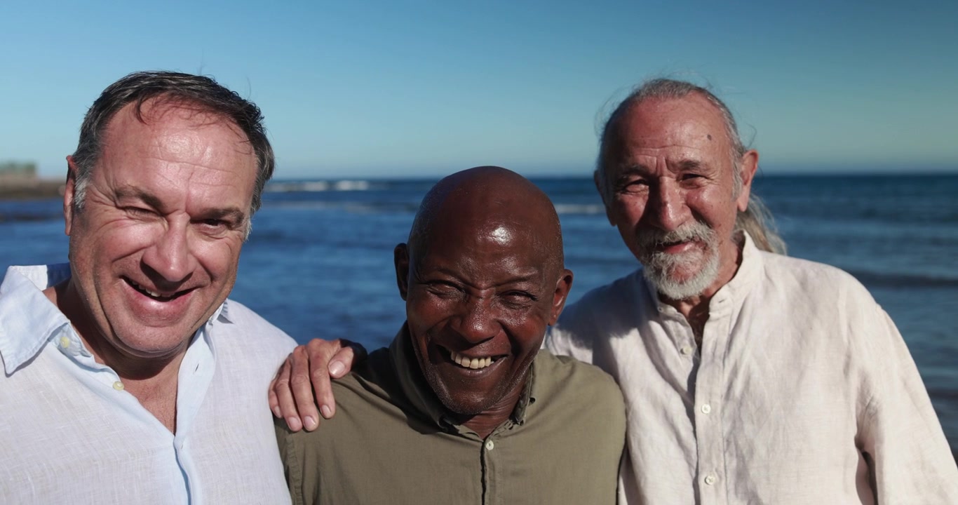 Happy Diverse Senior Men Smiling Together on the Beach