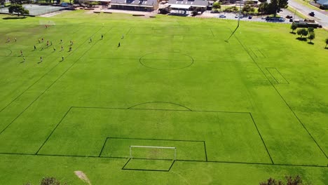 aerial view flying forward towards football pitch, perth australia