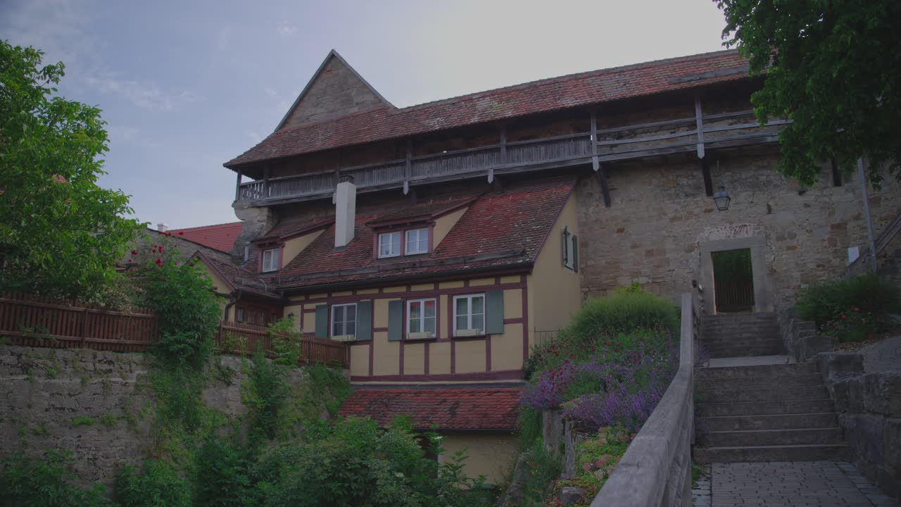 Old historical building in Rothenburg ob der Tauber, scenic stairway and greenery