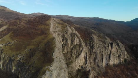 Aerial-shot-of-mountain-hill-with-forest-and-cliffs-4