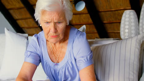 Front-view-of-old-Caucasian-senior-woman-using-laptop-at-home-4k