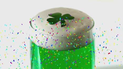 confetti animation over green beer with shamrock foam for saint patrick's day