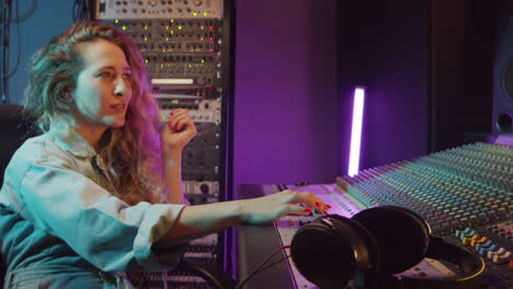 portrait of female sound engineer at work in recording studio