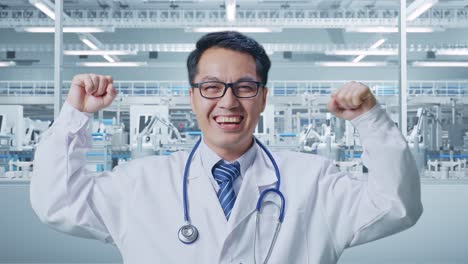 close up of asian male doctor with stethoscope smile and flex muscle in laboratory