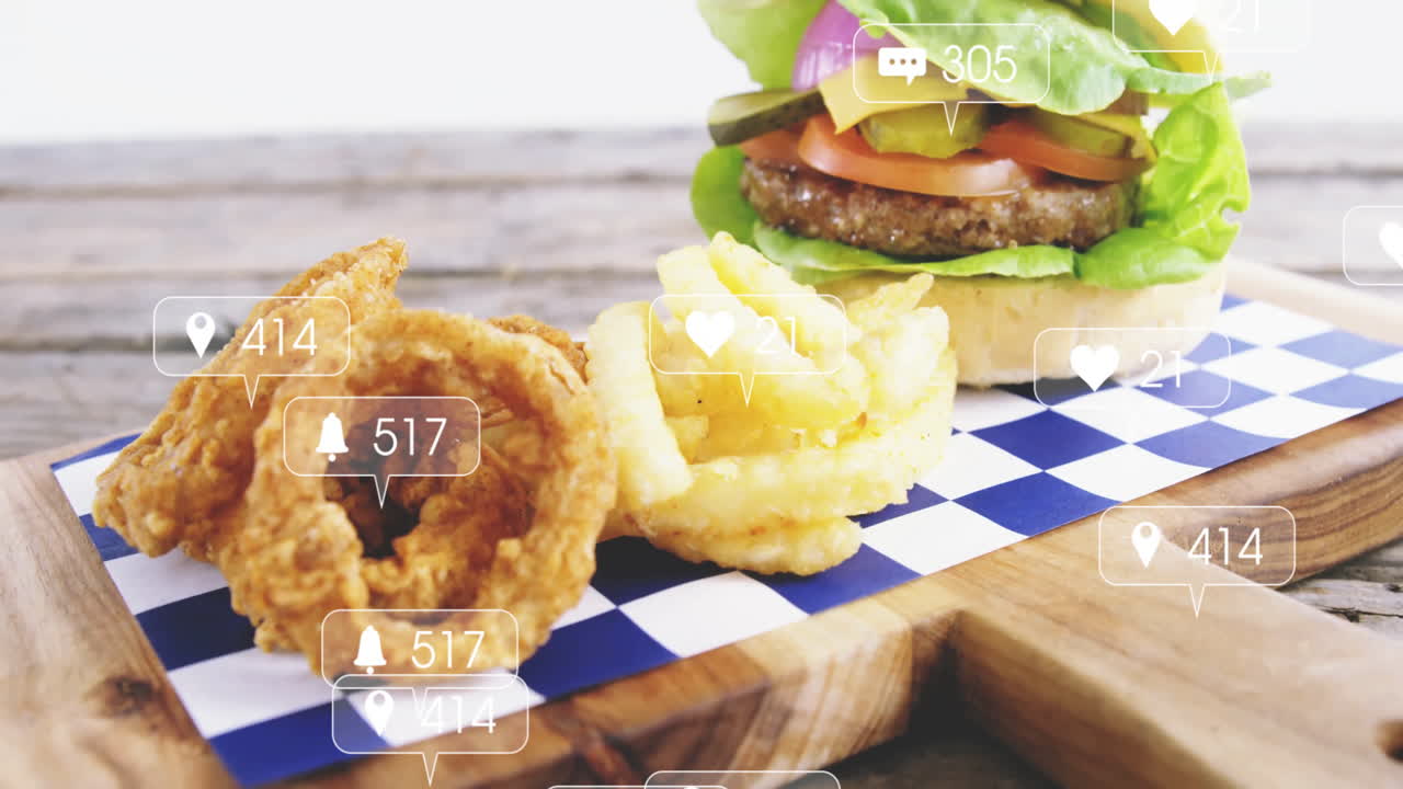 Burger and fries on wooden board with animation of social media notifications