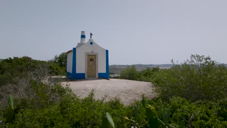 aerial drone 180º shot with bushes of ancient chapel of nossa senhora do monte in arruda dos vinhos in portugal