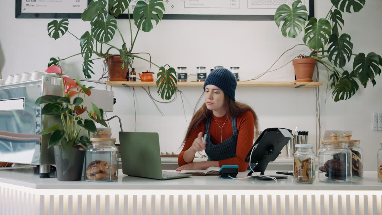 Woman working at a cafe counter
