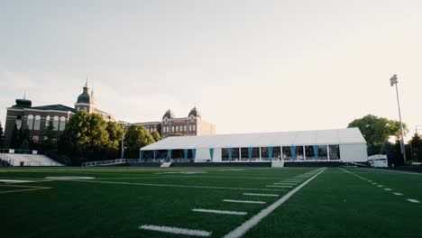 Einzigartige-Perspektivische-Luftaufnahme-Eines-Großen-Hochzeitszeltes-Auf-Dem-American-Football-Feld