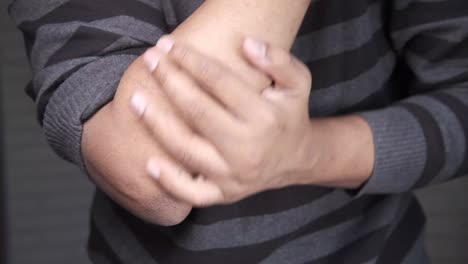 person examining their elbow