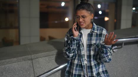 woman on phone in city at night