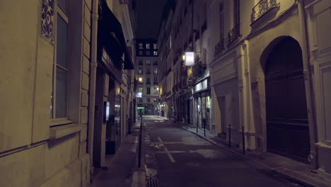 View down a narrow street in Paris France at night