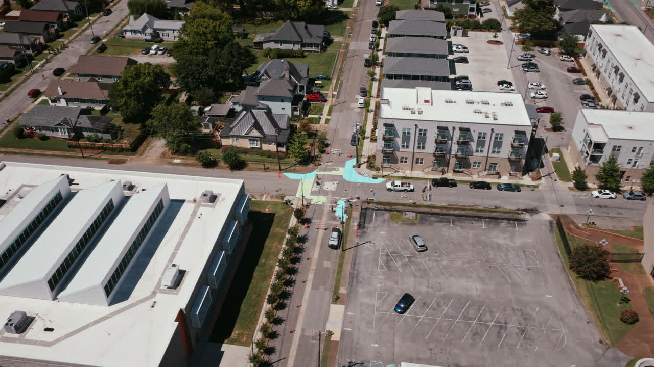Overhead timelapse view of a residential and mixed-use area in Chattanooga, showing modern apartments, homes, and painted street intersections
