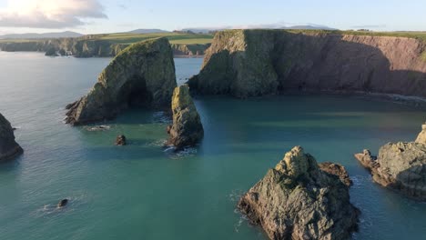 drone fly over sea stacks sea caves and hidden beach copper coast waterford ireland natures beauty