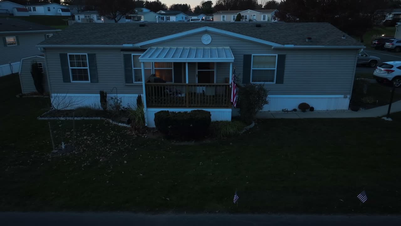 Mobile home trailer with American flag at night