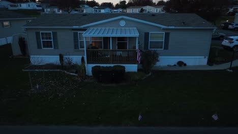 mobile home trailer with american flag at night