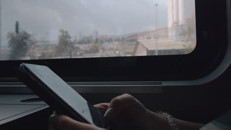 woman exchanging messages on mobile when traveling by train