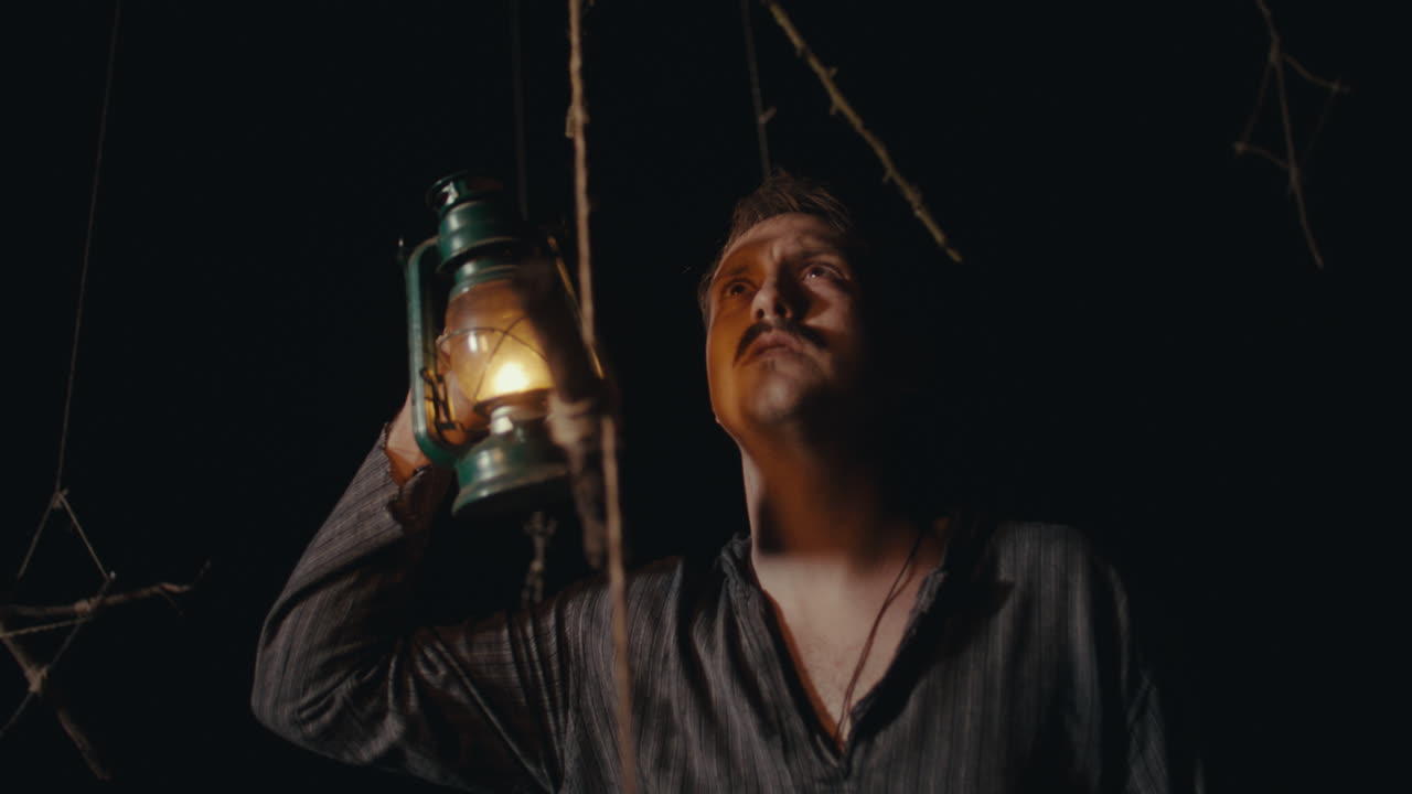 Man with Lantern in a Dark, Mysterious Setting
