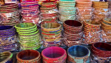 colorful bangles many at shop for sale at day from flat angle in details