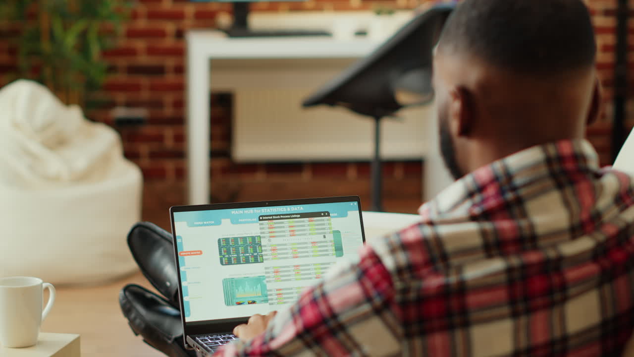 Man analyzing stock market data on laptop