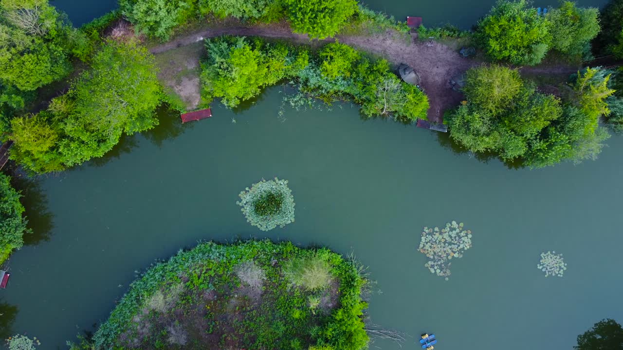 Top Down View Over Fishing Pond In The Countryside Norfolk Of England - drone shot