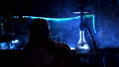 woman smoking hookah in a nightclub