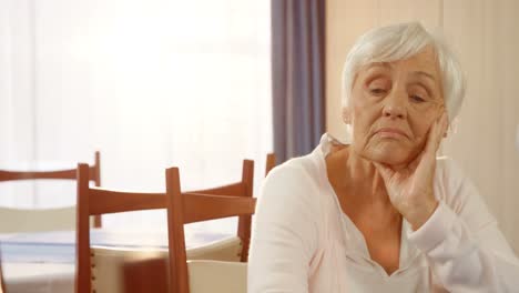 Unhappy-senior-woman-sitting-alone