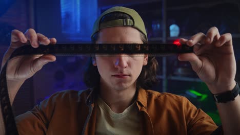 young man examining film reel