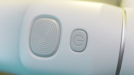 close-up of power button on a light gray device