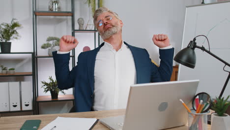 bored sleepy business man worker working on laptop computer, yawning, falling asleep at office