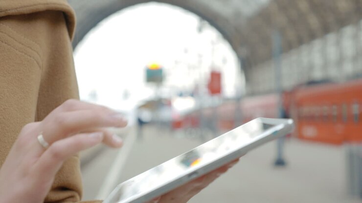 Girl typing on touch pad at the station