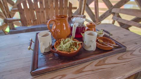 breakfast tray with tea and mugs on a wooden table, vacation breakfast concept, dolly shot