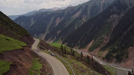 aerial view of drone moving forward over a high mountain pass near peer ki gali in kashmir